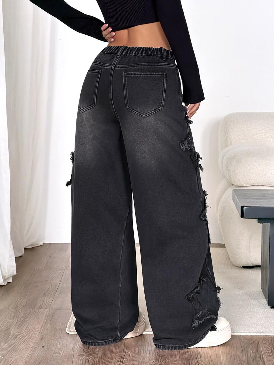 Front view of women's loose wide leg denim jeans featuring a mid waist, classic front pockets, and a zipper fly closure.
