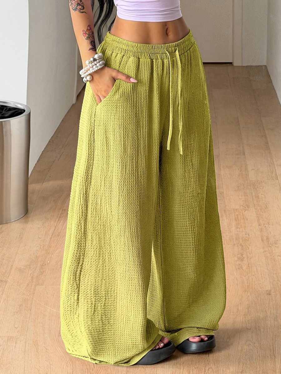 Women's loose fit straight leg lounge pants in textured knit fabric featuring an elastic drawstring waist and side pockets