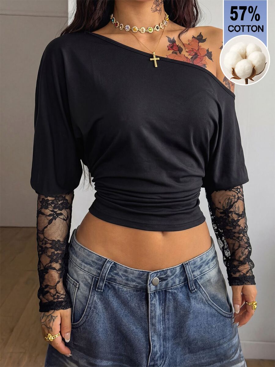Women's black long sleeve t-shirt featuring delicate contrast lace details and a boat neckline in a knitted stretch fabric.