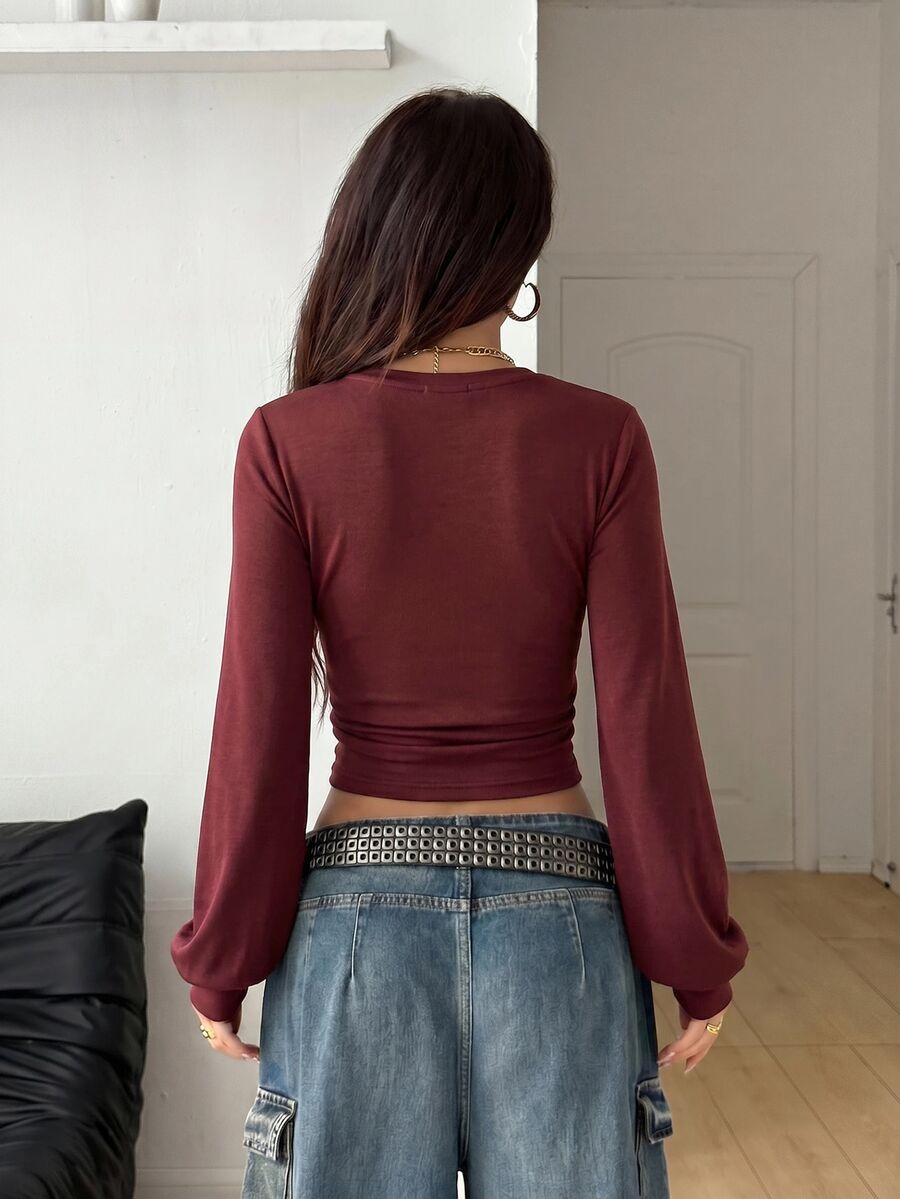 Women's brown waist-cinching sweatshirt featuring a round neck, drop shoulder long sleeves, and rib-knit cuffs.