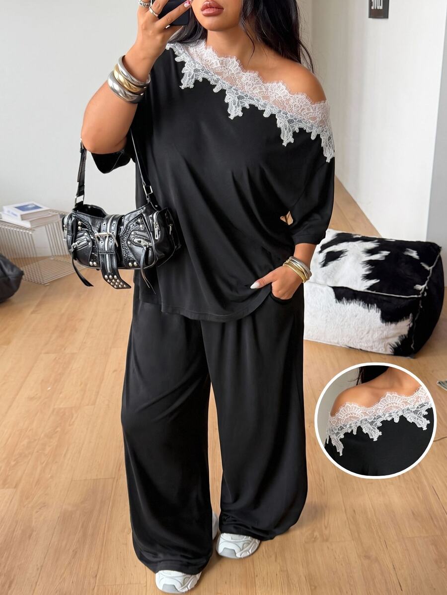 Women's casual two-piece outfit featuring a loose short-sleeve asymmetrical neck t-shirt and matching long wide leg pants with pockets.