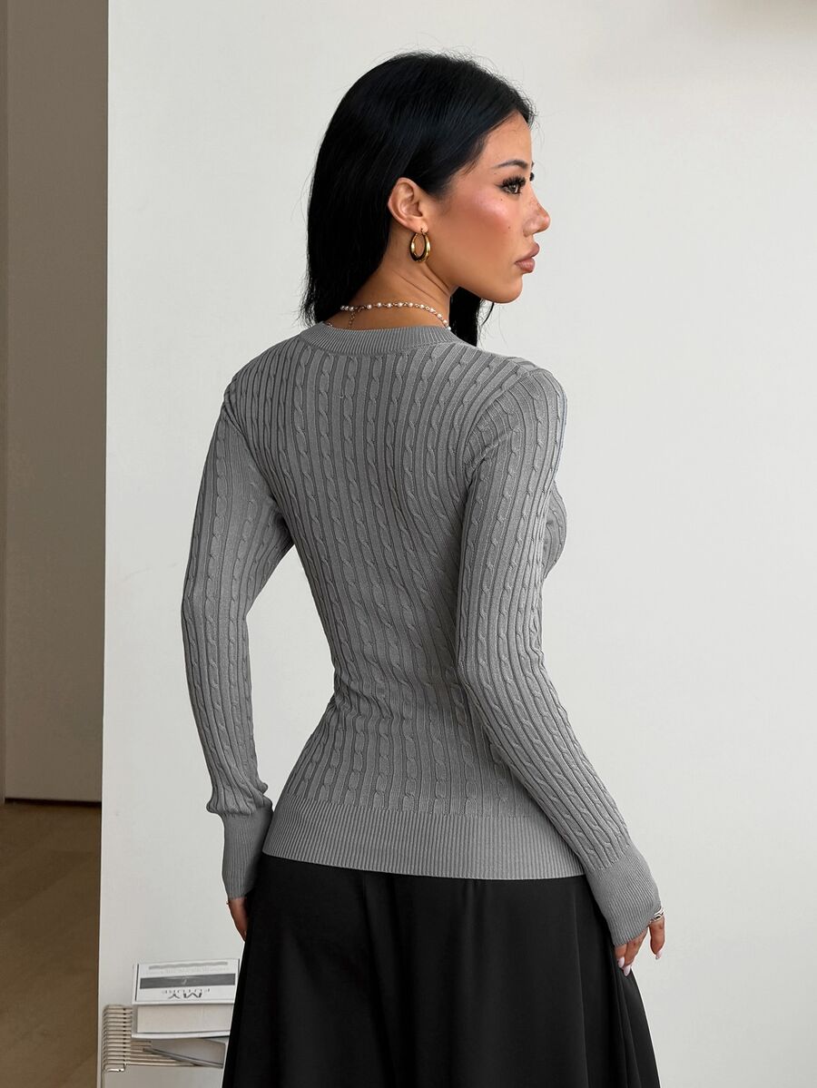 Women's slim fit cable-knit sweater with a V-neckline and long sleeves in solid green rib knit fabric.