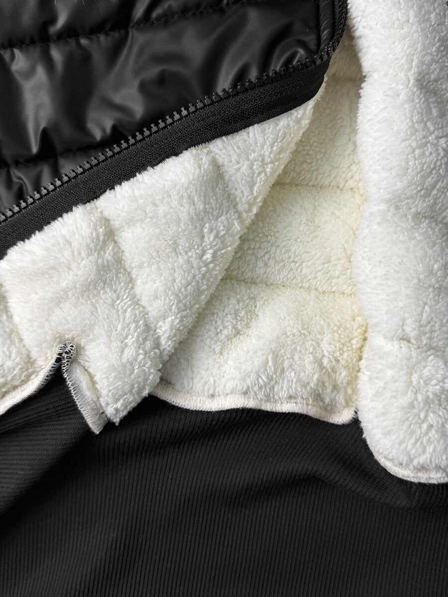 Women's brown cropped puffer jacket featuring a faux fur trimmed hood, front zipper, and ribbed hem.