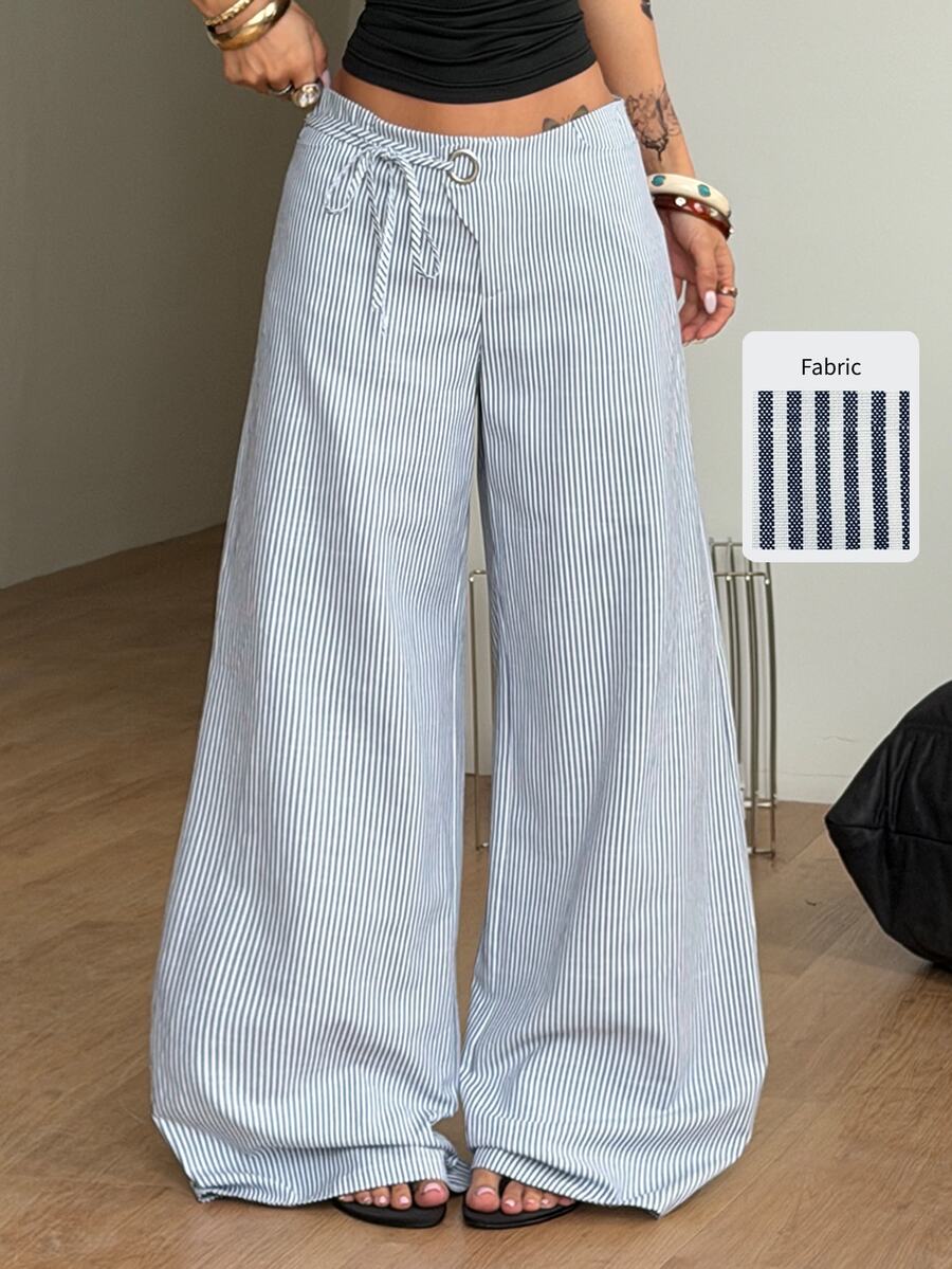 Women's blue and white striped woven wide leg long pants featuring side knot ties and grommet eyelet details.