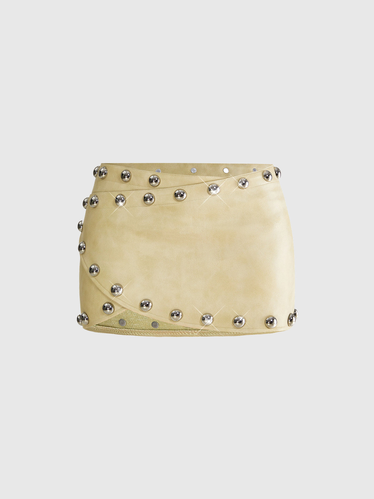 Women's bodycon mini skirt featuring an ultra low layered waistline with studded rivet details in a solid color finish.
