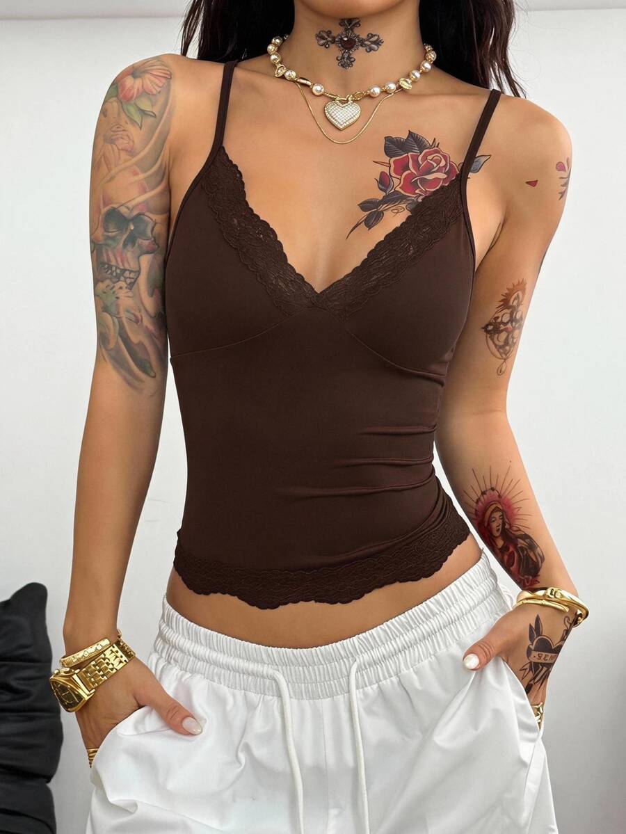 Slim fit cropped camisole top for women featuring contrast lace trim, ruched cup detailing, and delicate spaghetti straps.