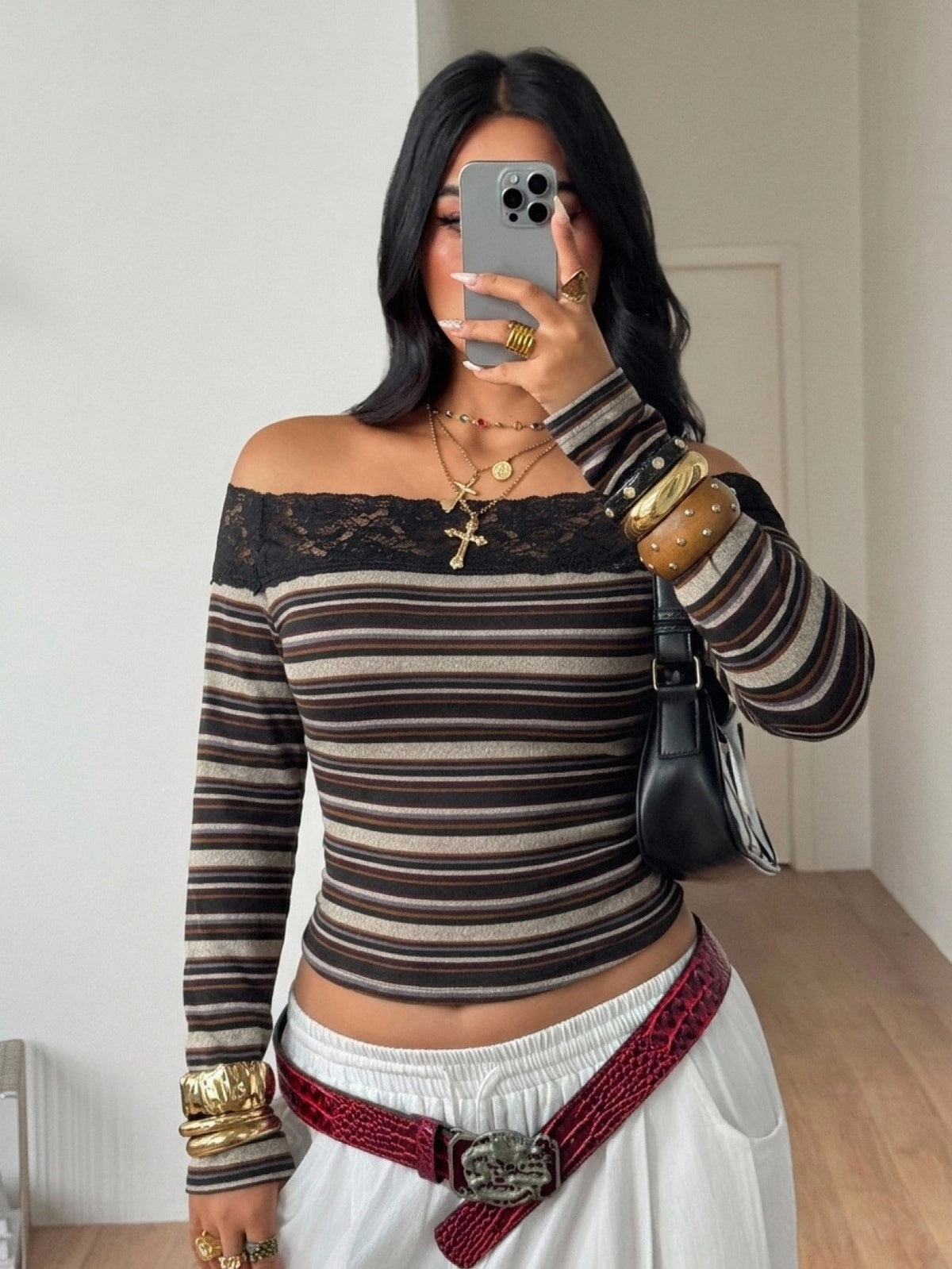 Women's striped off the shoulder long-sleeve top with contrast lace trim and ribbed knit texture.