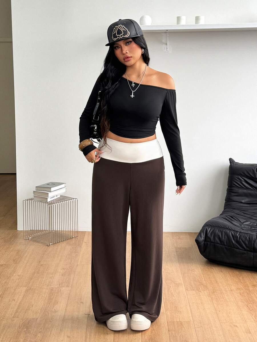 Women's casual straight leg sweatpants featuring a black and white polka dot design with an elastic waistband.