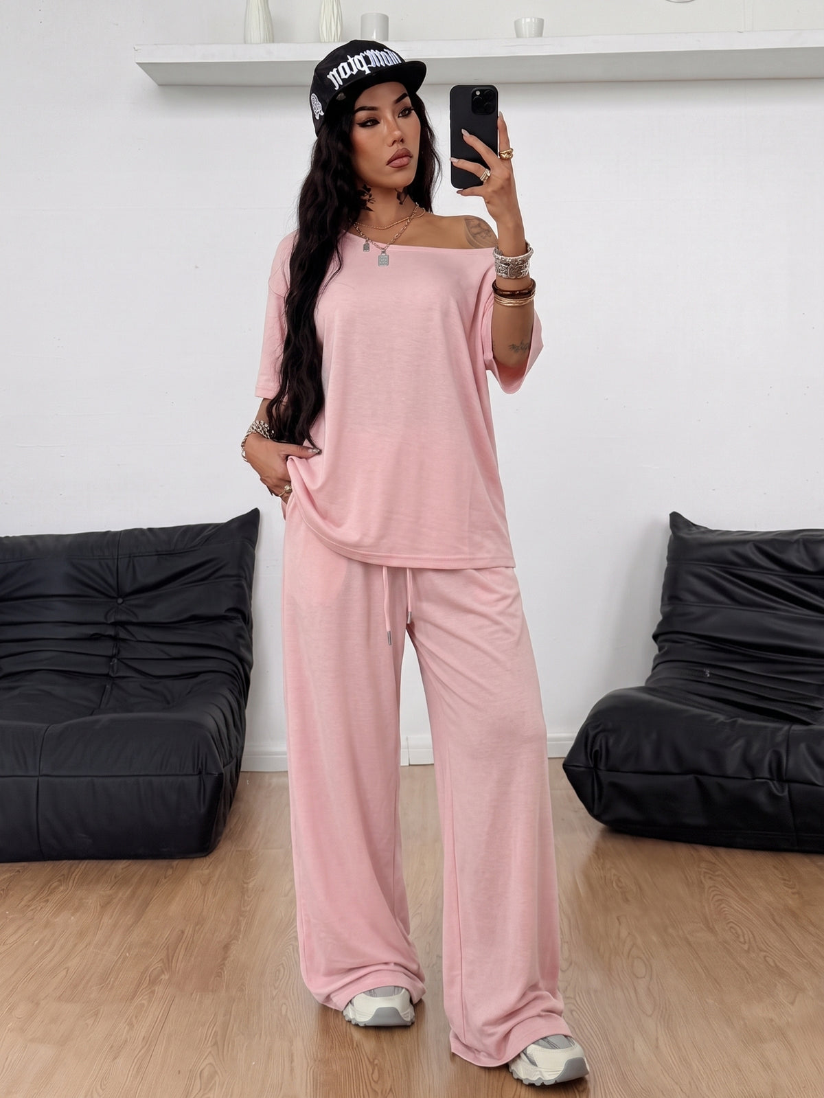 Women's two-piece outfit featuring an oversized asymmetrical neck t-shirt and matching wide-leg drawstring sweatpants.