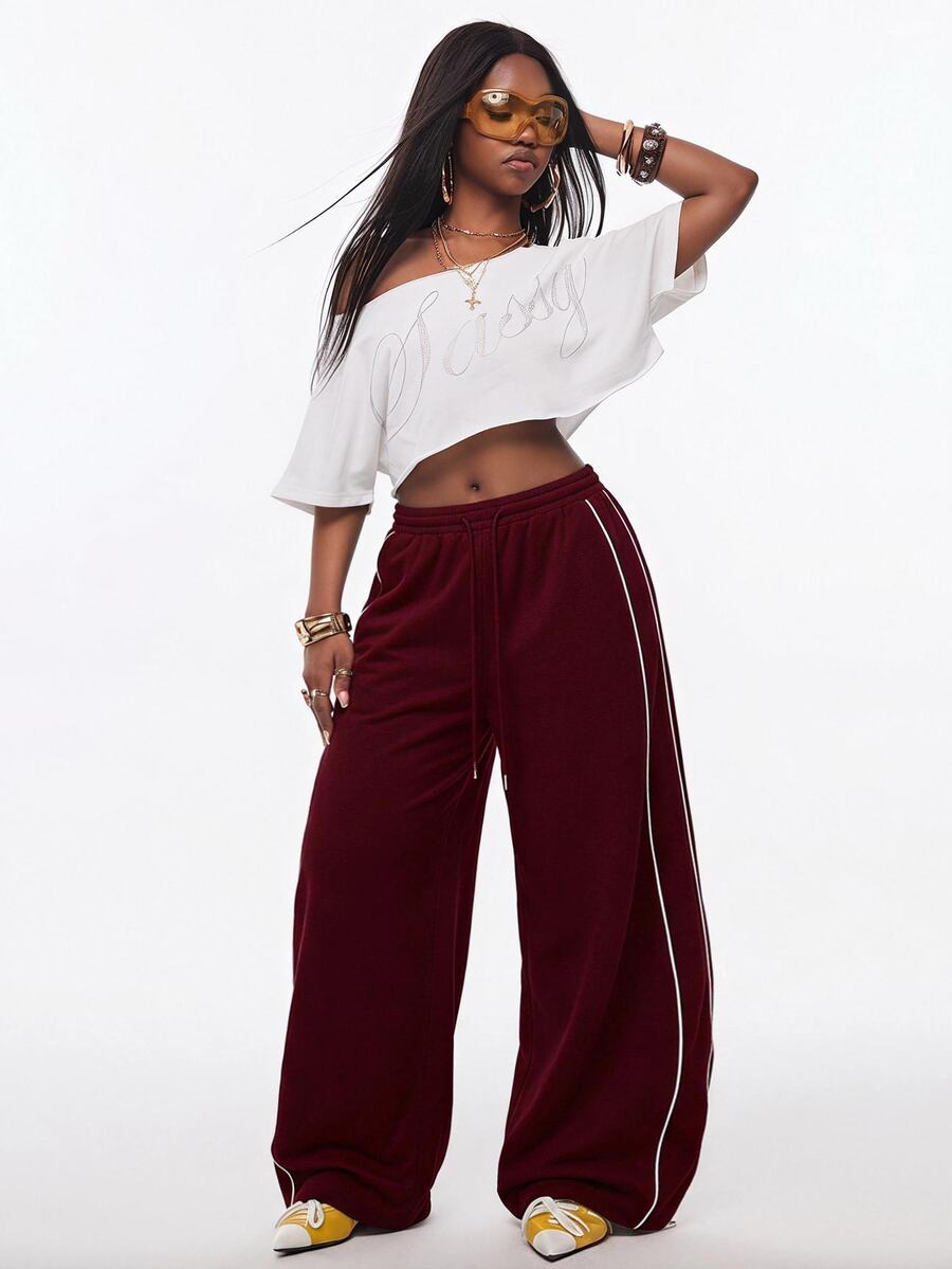 Women's wide leg trousers with a tree branch graphic pattern, loose fit, and mid-rise waist in woven fabric.