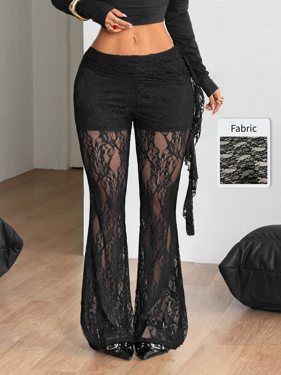 Women's black and white polka dot flare leg pants with side drawstring and ruched details