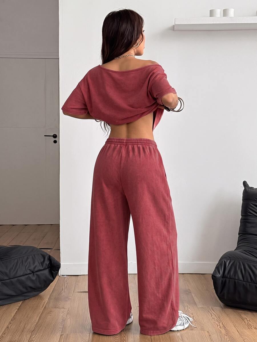 Women's two-piece outfit featuring an oversized asymmetrical neck t-shirt and matching wide-leg drawstring sweatpants.
