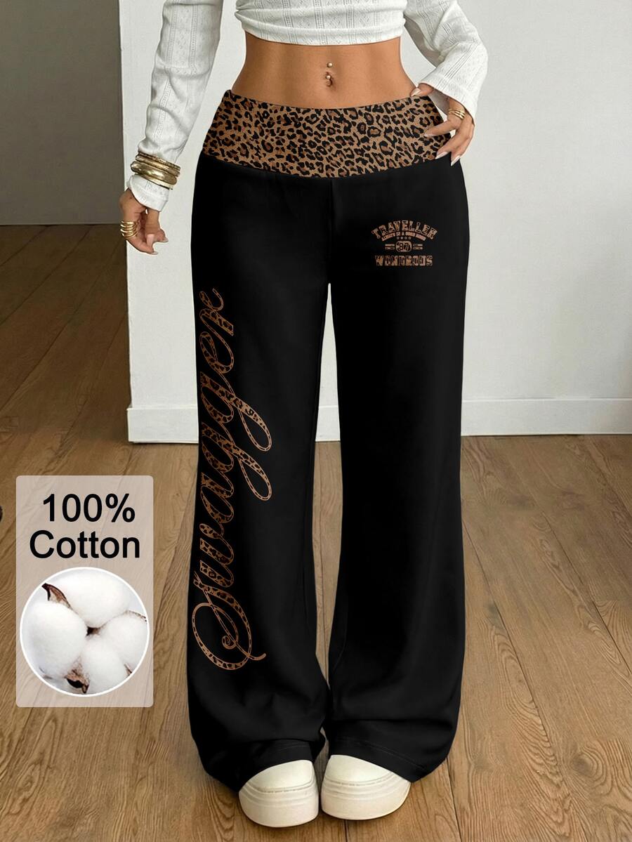 Women's casual straight leg sweatpants featuring a black and white polka dot design with an elastic waistband.