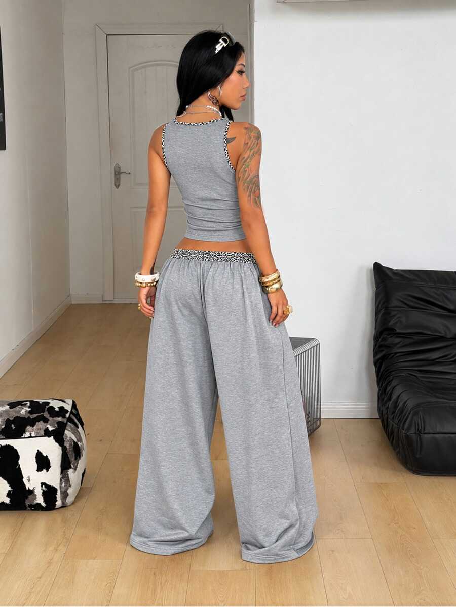 Women's two-piece casual outfit featuring a slim-fit camisole tank top with ruffle trim and button front paired with high-waisted wide leg pants.