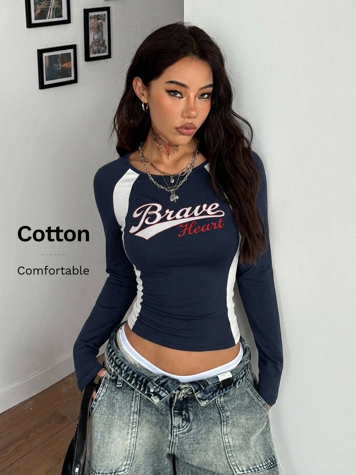 Women's slim fit long sleeve raglan t-shirt with collegiate letter graphic print, round neck, and contrast binding.