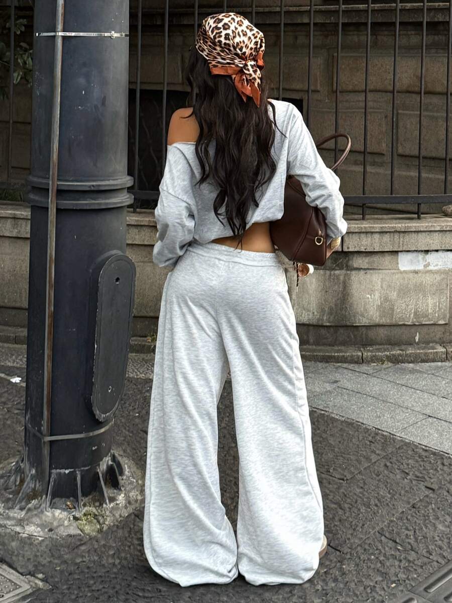 Women's casual straight leg baggy lounge pants in light grey with an adjustable drawstring waist and side pockets.