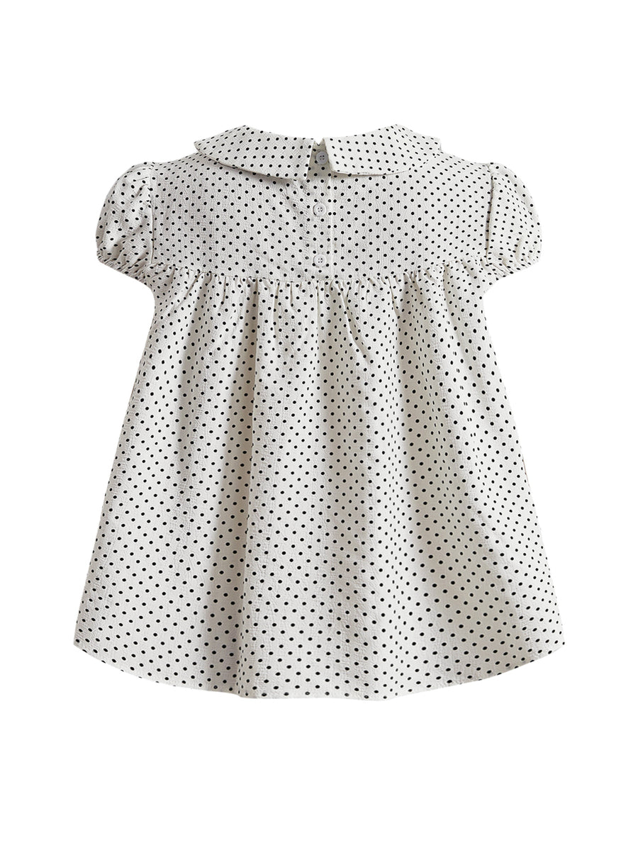 Short sleeve plaid shirt for women featuring a Peter Pan collar with a bow accent, puff sleeves, and a flared hem.