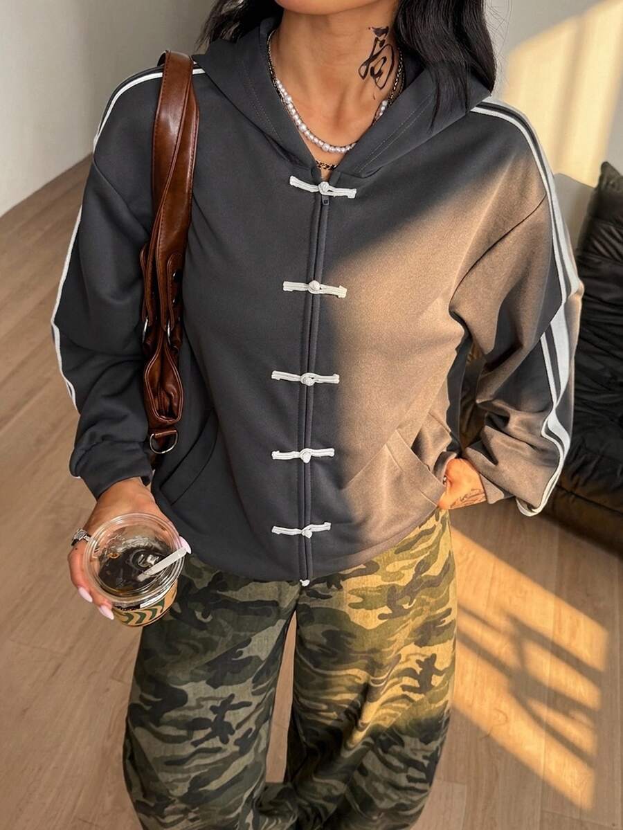 Women's army green camo zip up hoodie with drop shoulder sleeves, front pockets, and drawstring hood