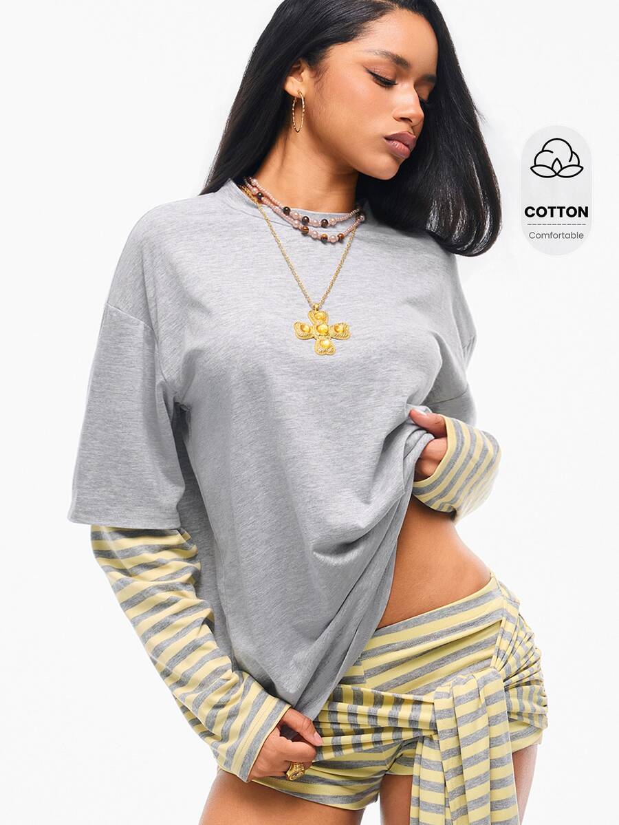 Women's casual graphic long sleeve t-shirt with a round neck, drop shoulder sleeves, and loose relaxed fit.