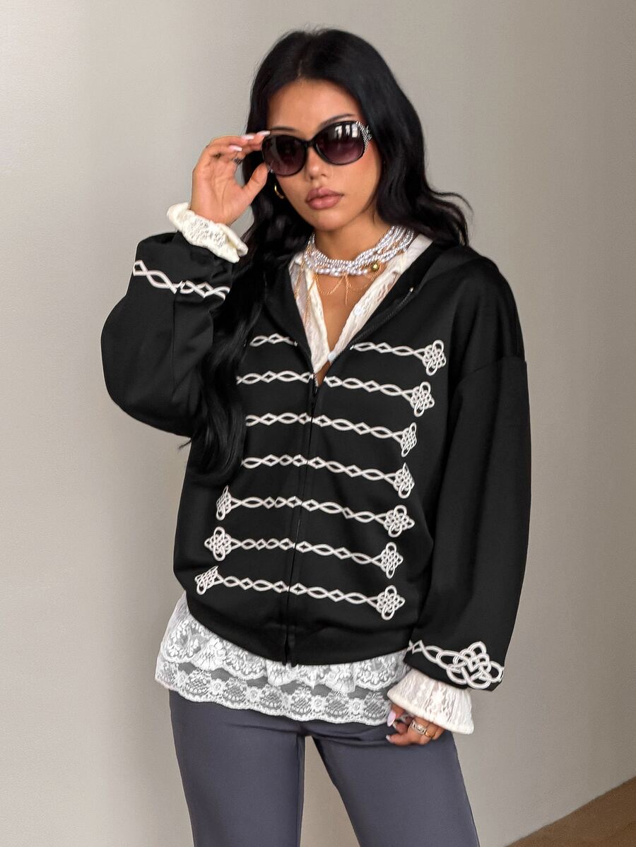 Women's army green camo zip up hoodie with drop shoulder sleeves, front pockets, and drawstring hood