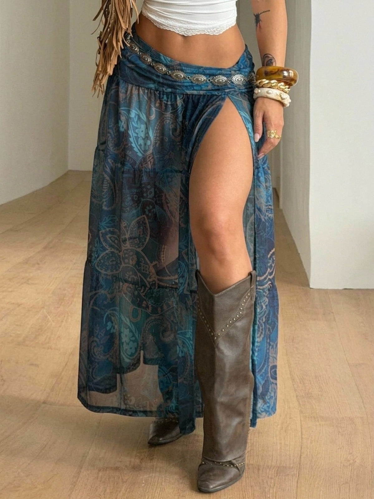 Women's low rise flared long skirt featuring an all-over print, split thigh accent, and textured semi-sheer fabric.