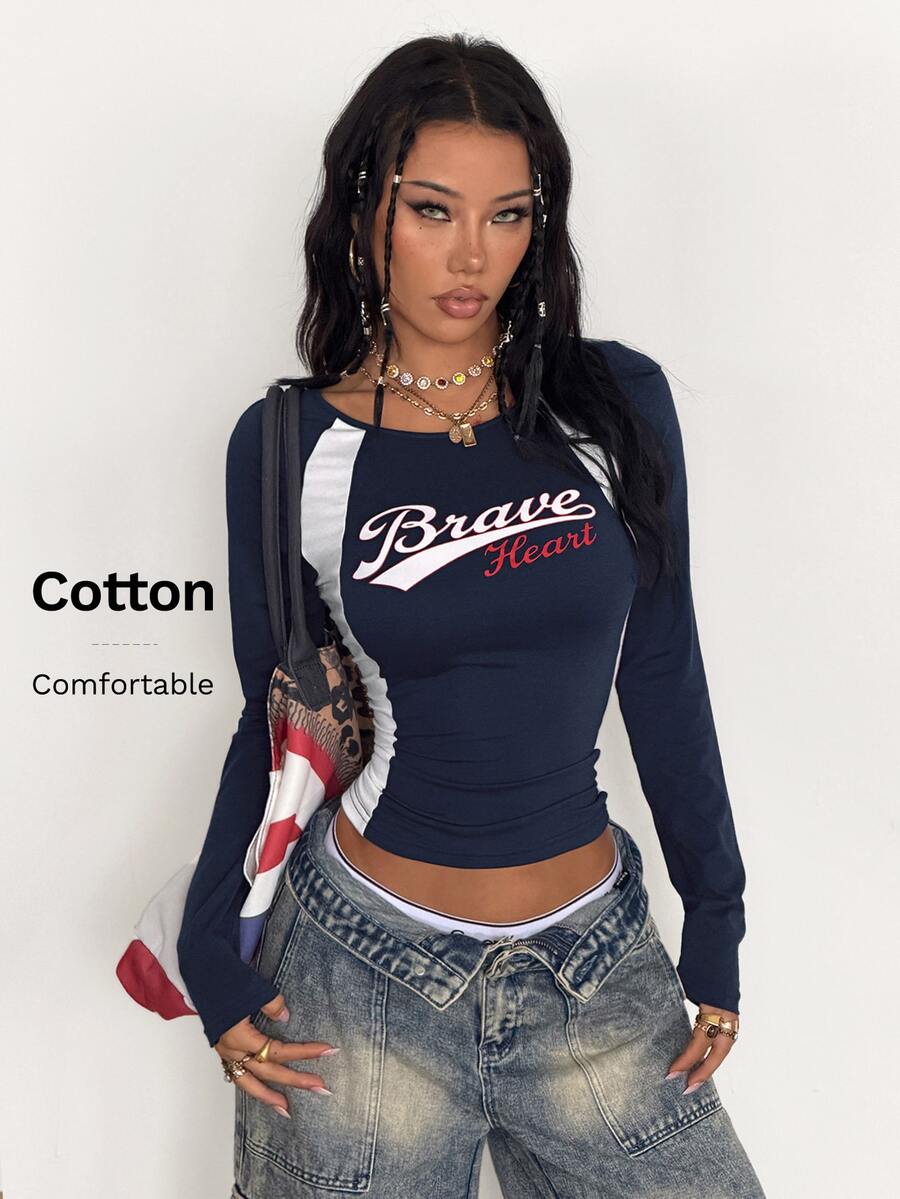 Women's slim fit long sleeve raglan t-shirt with collegiate letter graphic print, round neck, and contrast binding.