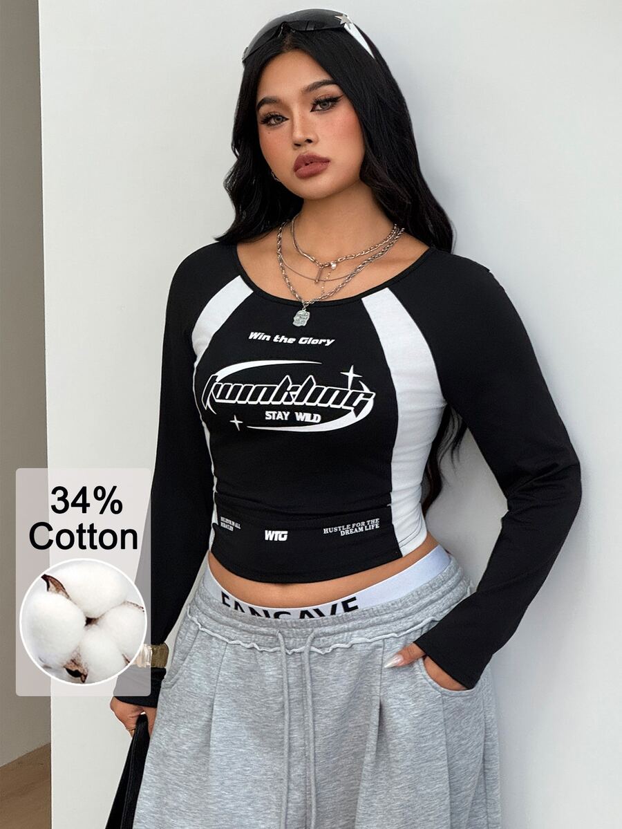 Women's plus size black and white colorblock long sleeve t-shirt with raglan sleeves and scoop neckline.