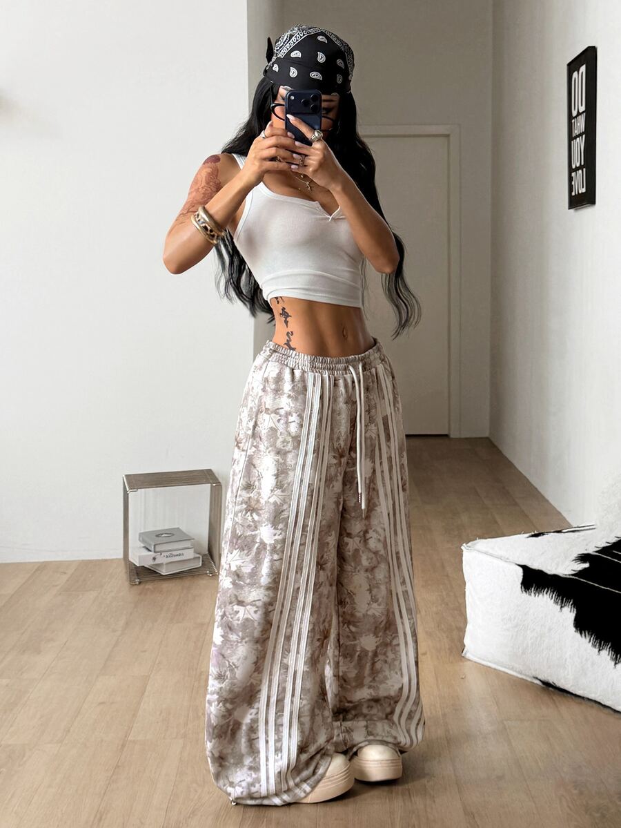 Women's loose fit wide leg graphic sweatpants in light grey with an elastic drawstring waistband