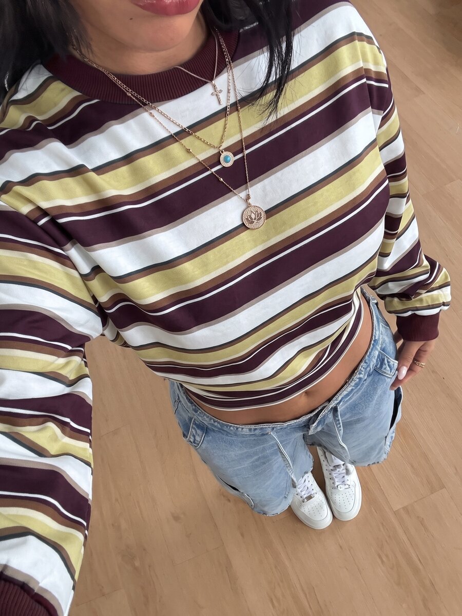 Women's striped pullover sweatshirt featuring drop shoulder long sleeves and a classic round neckline.