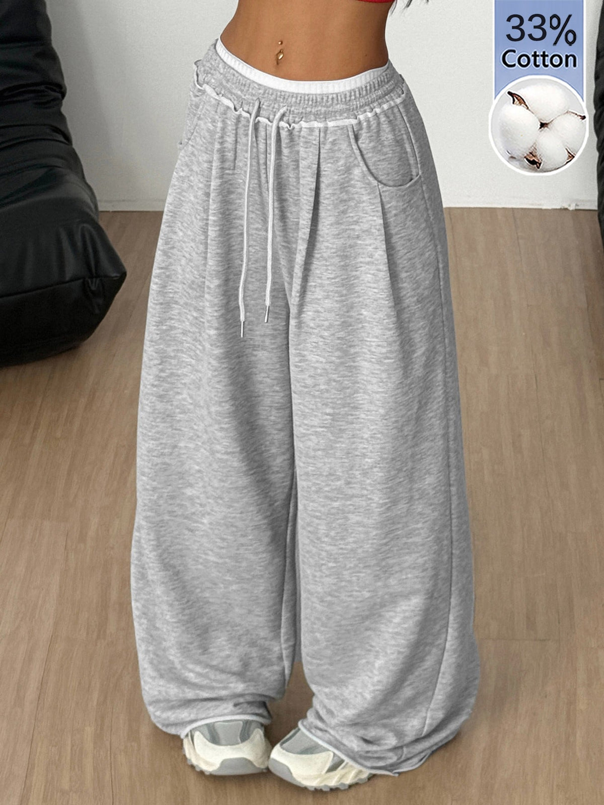 Women's casual straight leg baggy lounge pants in light grey with an adjustable drawstring waist and side pockets.