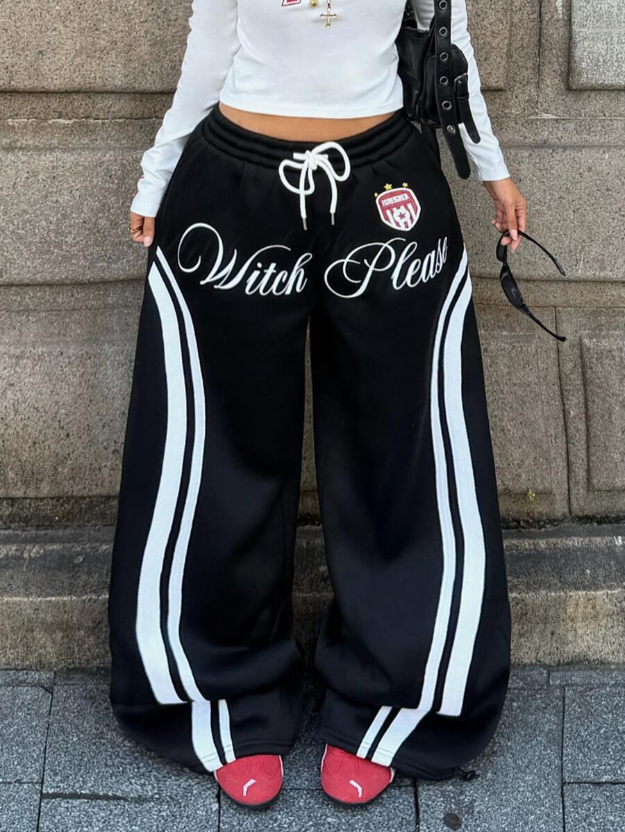 Women's loose fit wide leg graphic sweatpants in light grey with an elastic drawstring waistband