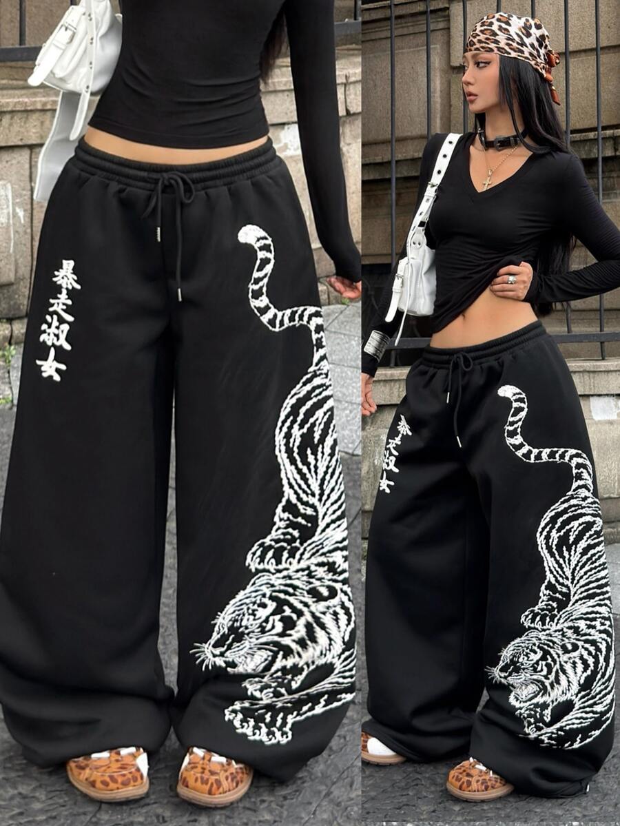 Women's loose fit wide leg graphic sweatpants in light grey with an elastic drawstring waistband