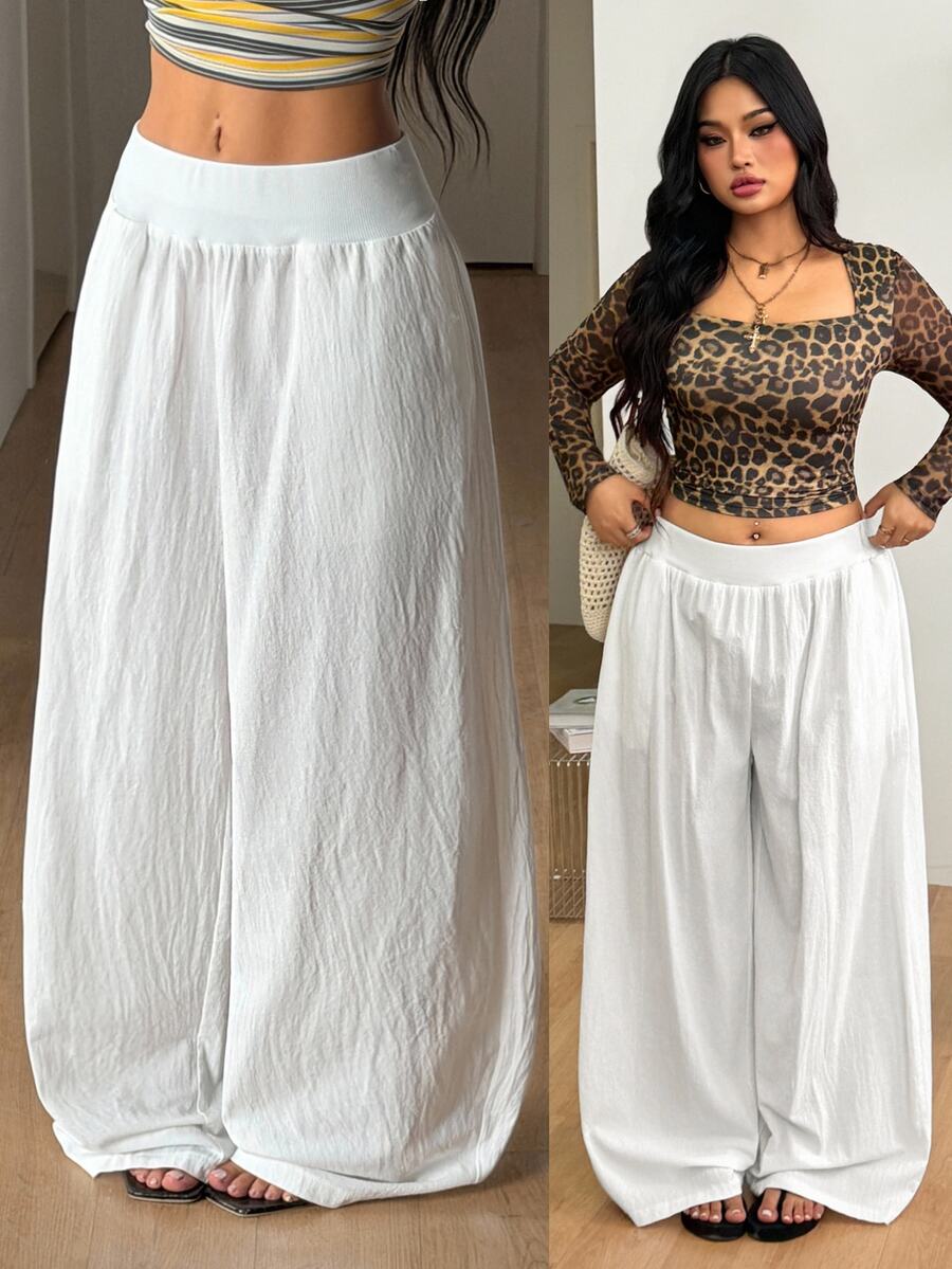 Plus size women's striped loose straight leg cropped pants with pleated detailing and side pockets