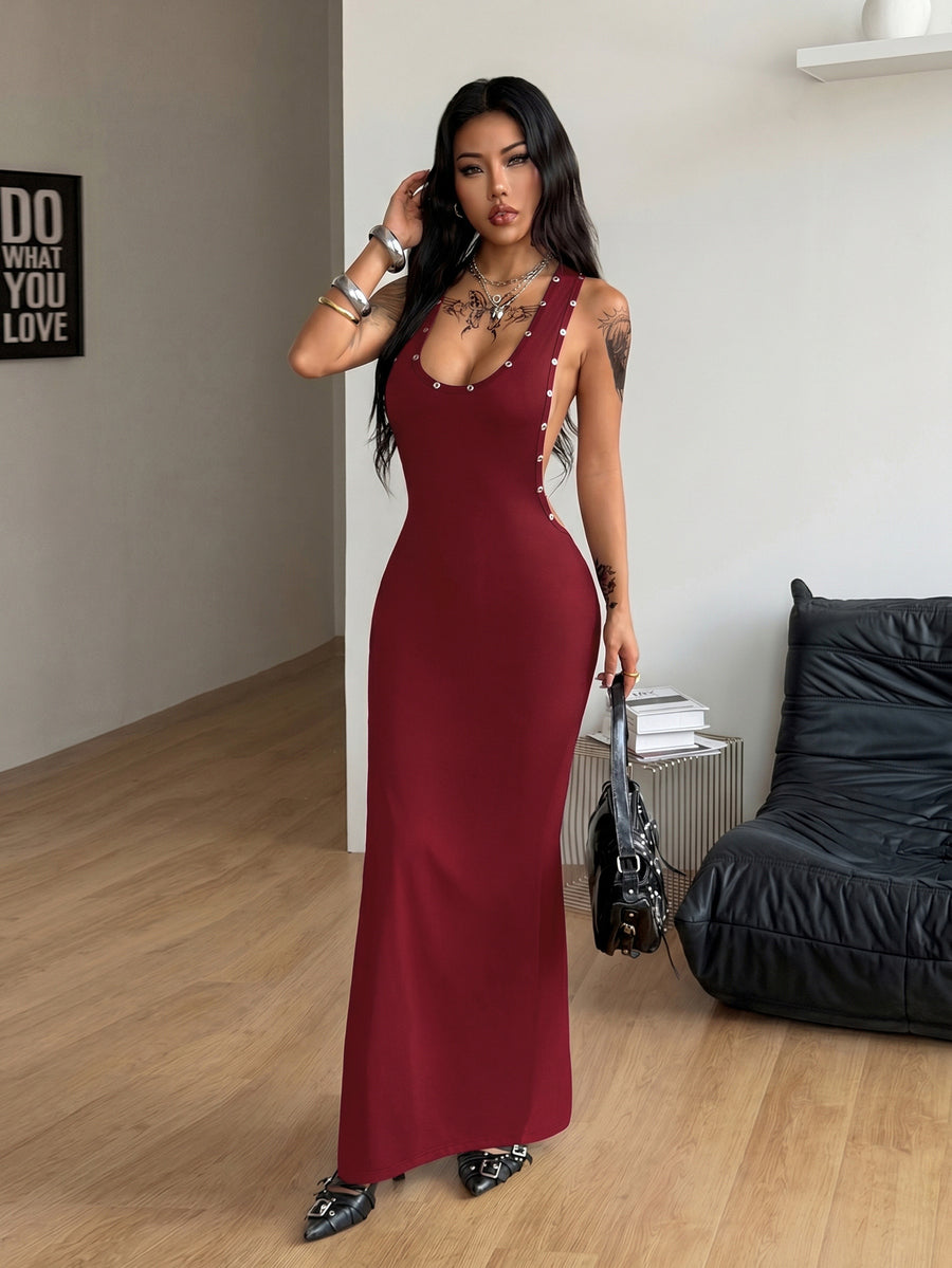 Front and side view of a women's black sleeveless bodycon maxi dress featuring a round neckline, open back, and high leg slit with metallic grommet eyelet details.