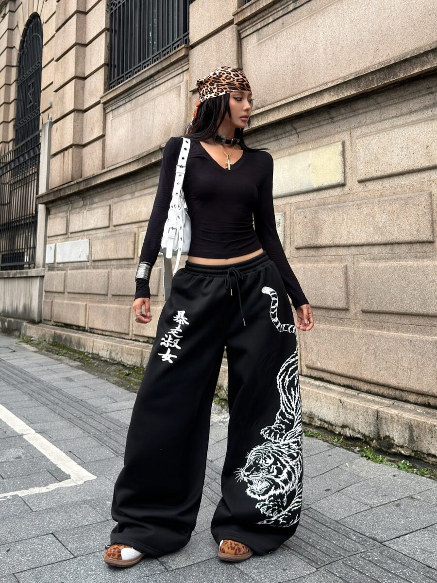 Women's loose fit wide leg graphic sweatpants in light grey with an elastic drawstring waistband