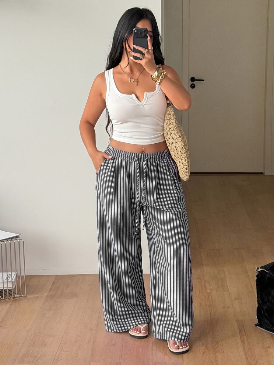 Plus size women's striped loose straight leg cropped pants with pleated detailing and side pockets