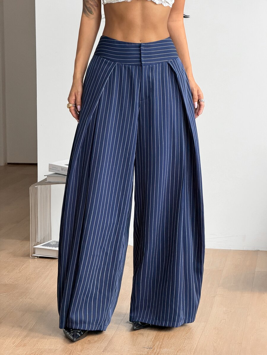 Women's brown striped wide leg pants with a low waist, curved hem, and loose casual fit in woven fabric.