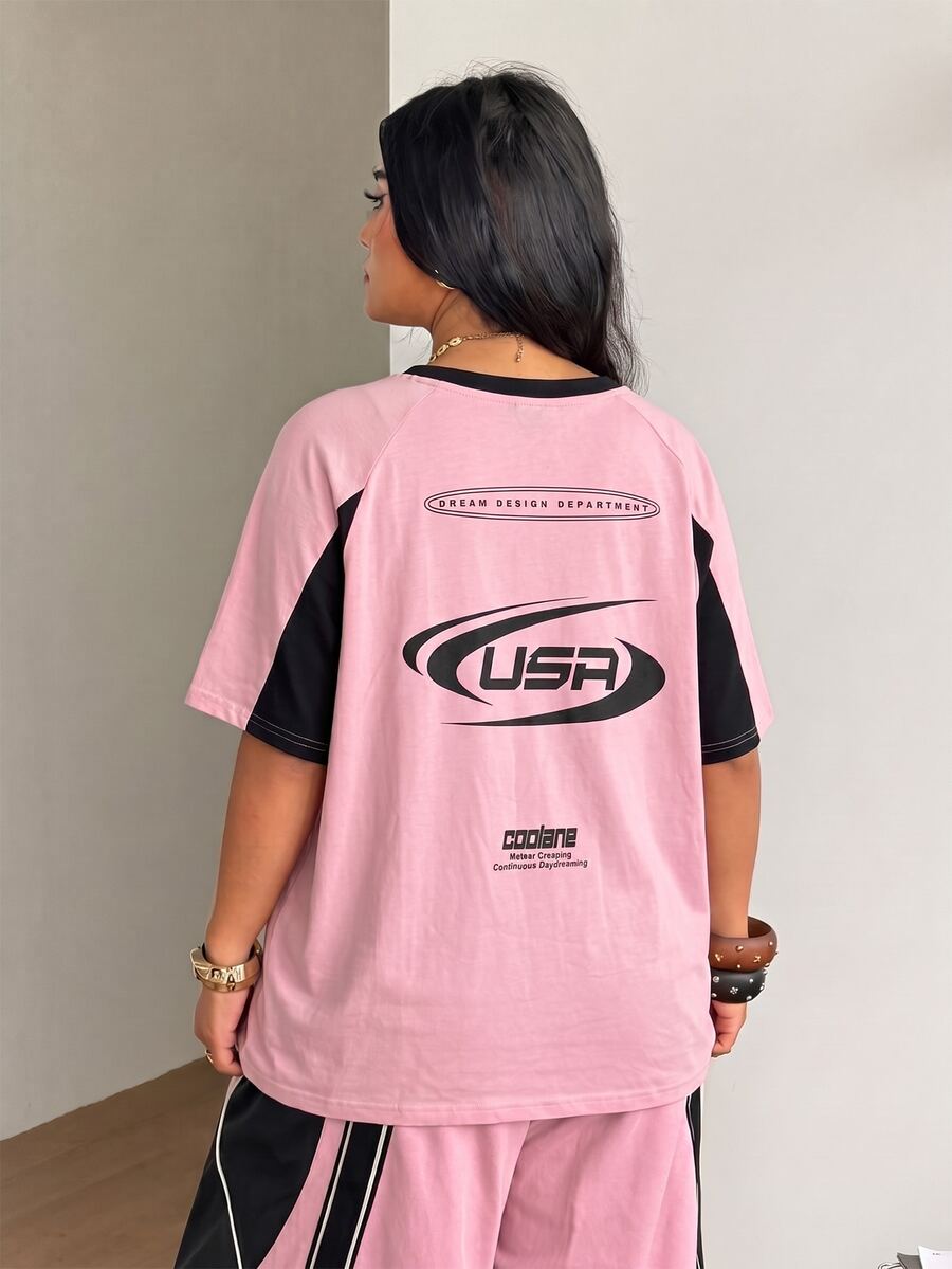 Unisex plus size oversized jersey t-shirt in brown featuring a round neck, short raglan sleeves with contrast binding, and a front letter graphic print.