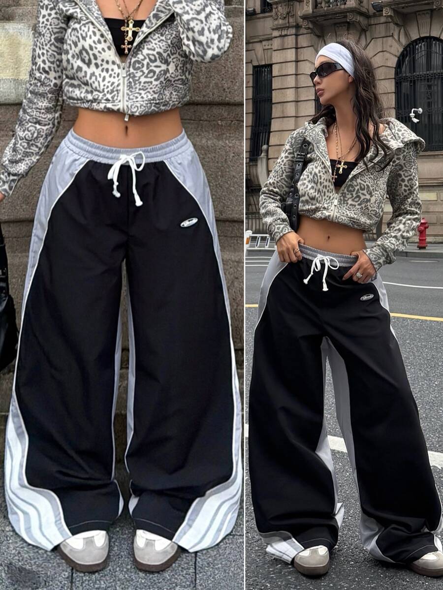 Women's loose fit straight leg pants in black and white with banded texture design, low drawstring waist, and pockets.