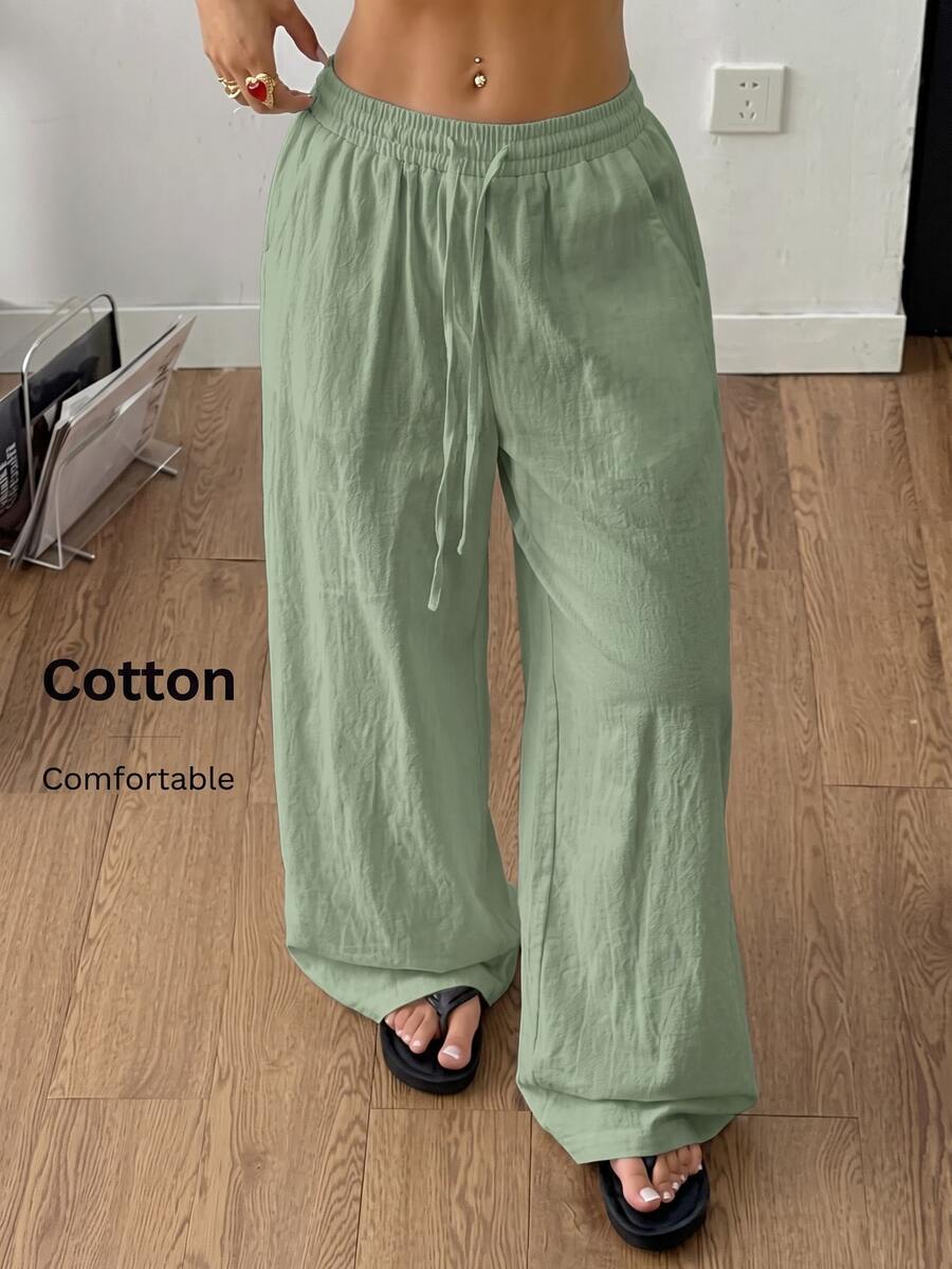 Plus size women's striped loose straight leg cropped pants with pleated detailing and side pockets