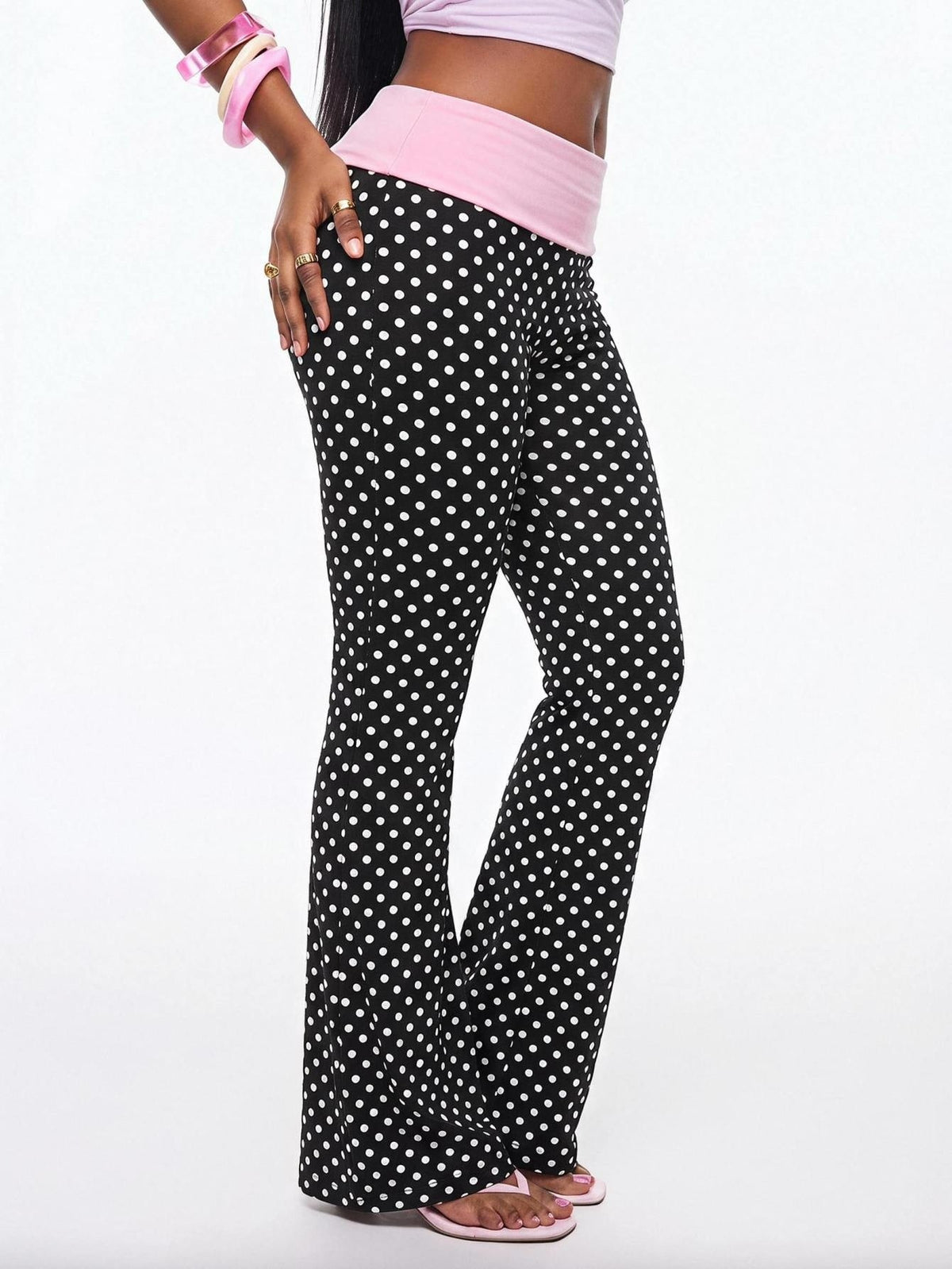 Women's black and white polka dot flare leg pants with side drawstring and ruched details