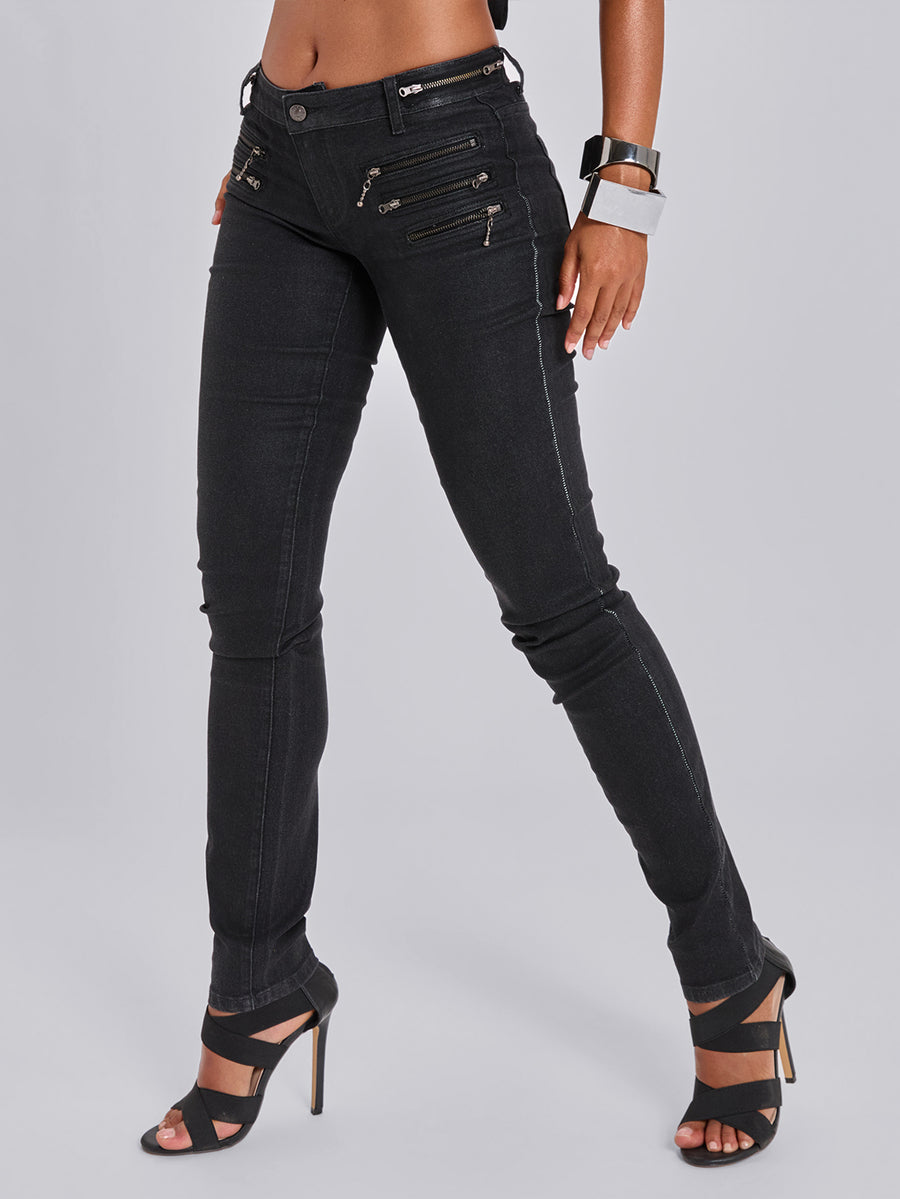 Black ultra low waist skinny denim pants for women featuring multi-layer decorative zippers, button closure, and high-stretch fabric.