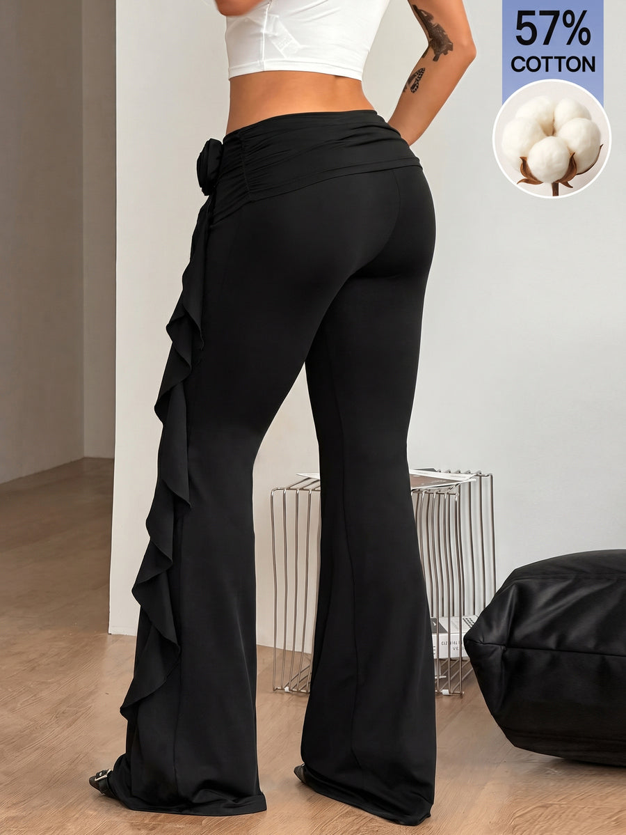 Black low waist flare pants featuring 3D rose and side stripe detailing in stretchy mesh fabric.
