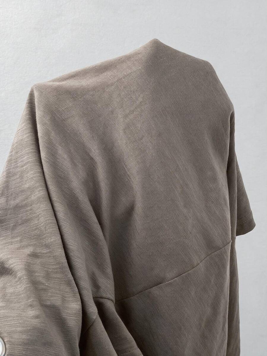 Women's casual loose fit cold shoulder cotton t-shirt with asymmetrical cutout neckline and short sleeves.