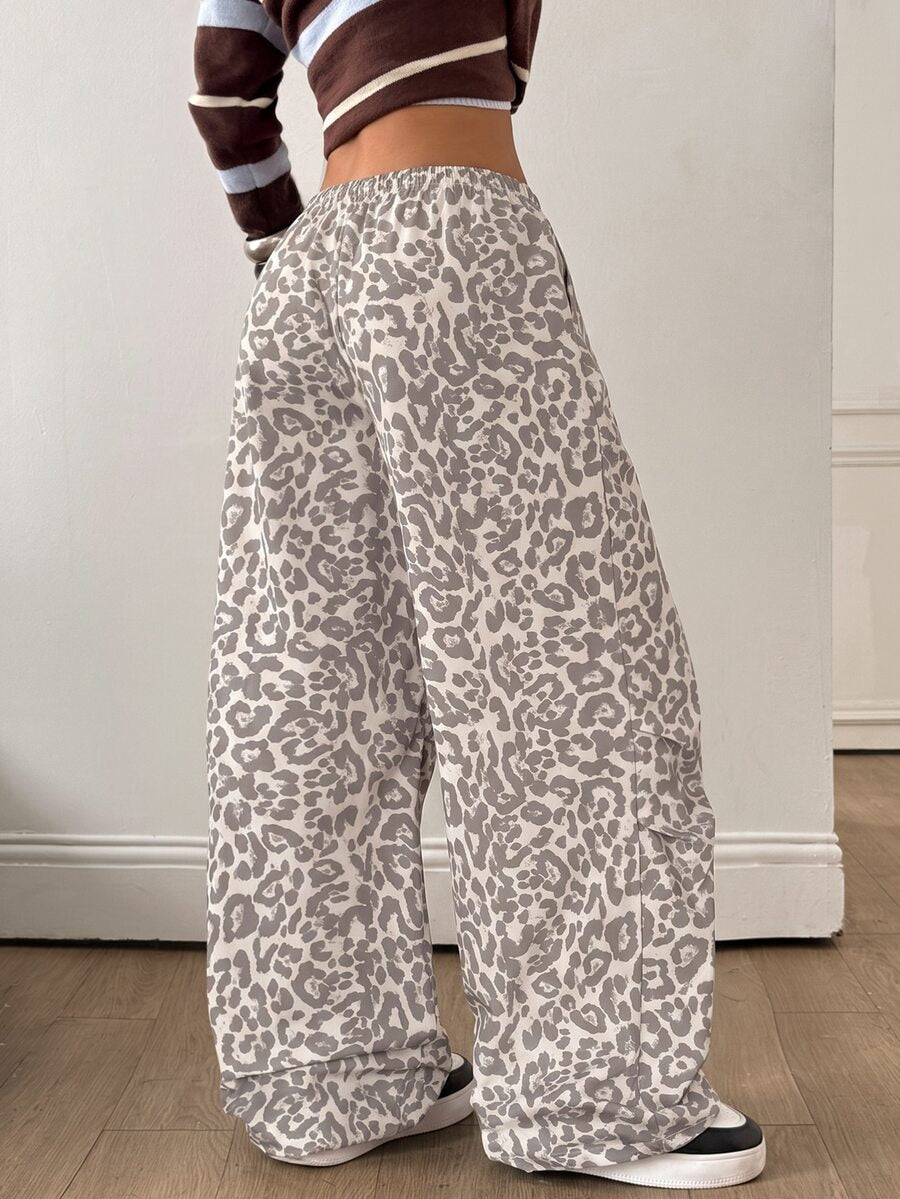 Women's black baggy jogger pants with an adjustable drawstring waist and colorblock polka dot geometric pattern.