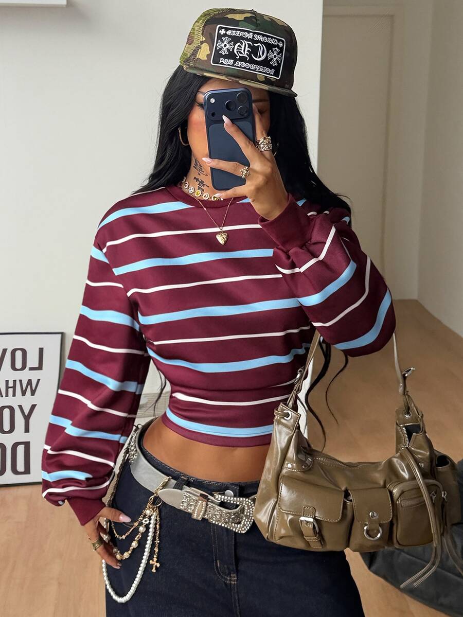 Women's striped pullover sweatshirt featuring drop shoulder long sleeves and a classic round neckline.