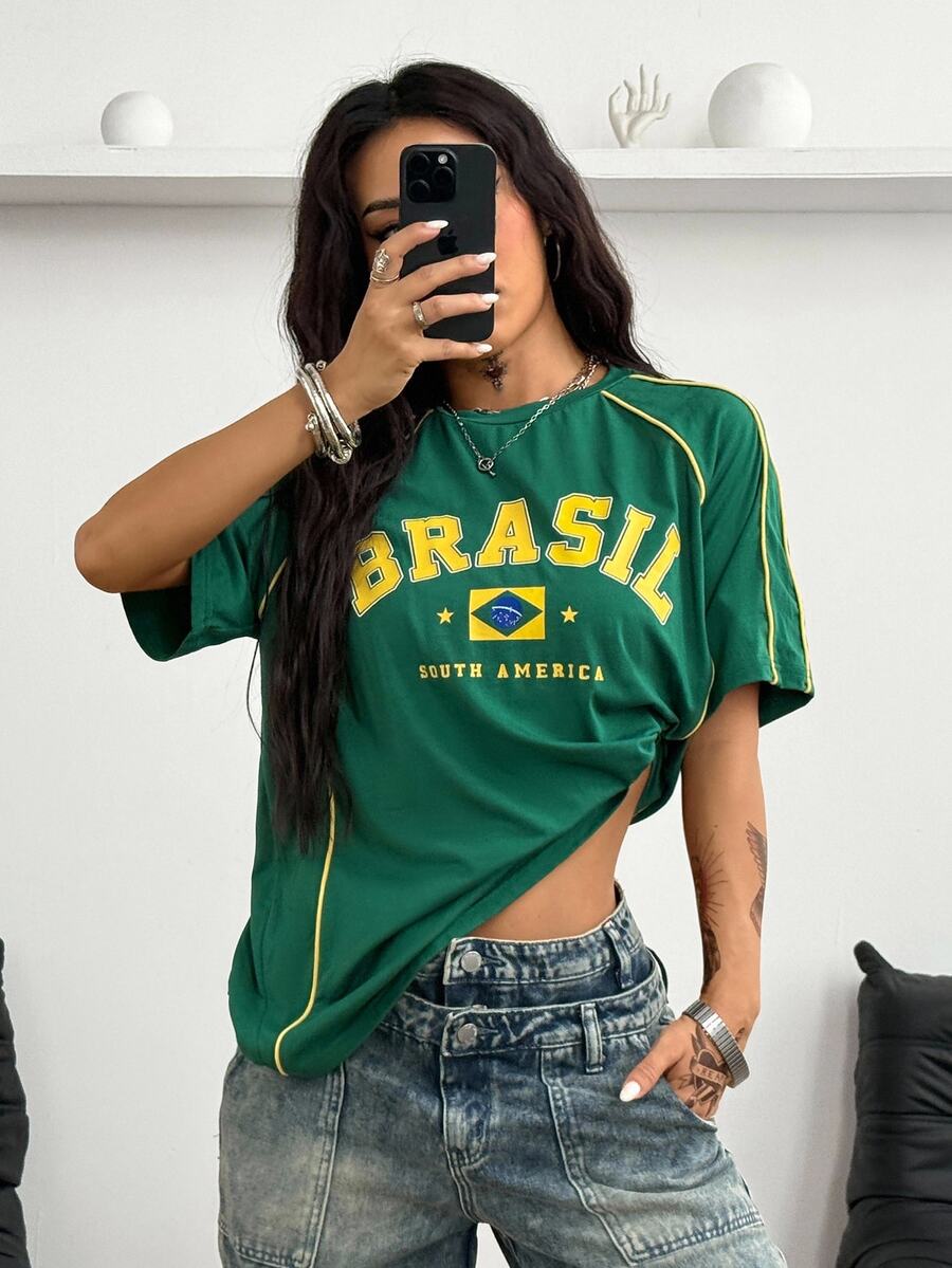 Yellow oversized graphic t-shirt featuring Brazil letter print on the front with contrast raglan sleeves and side stripe detailing.