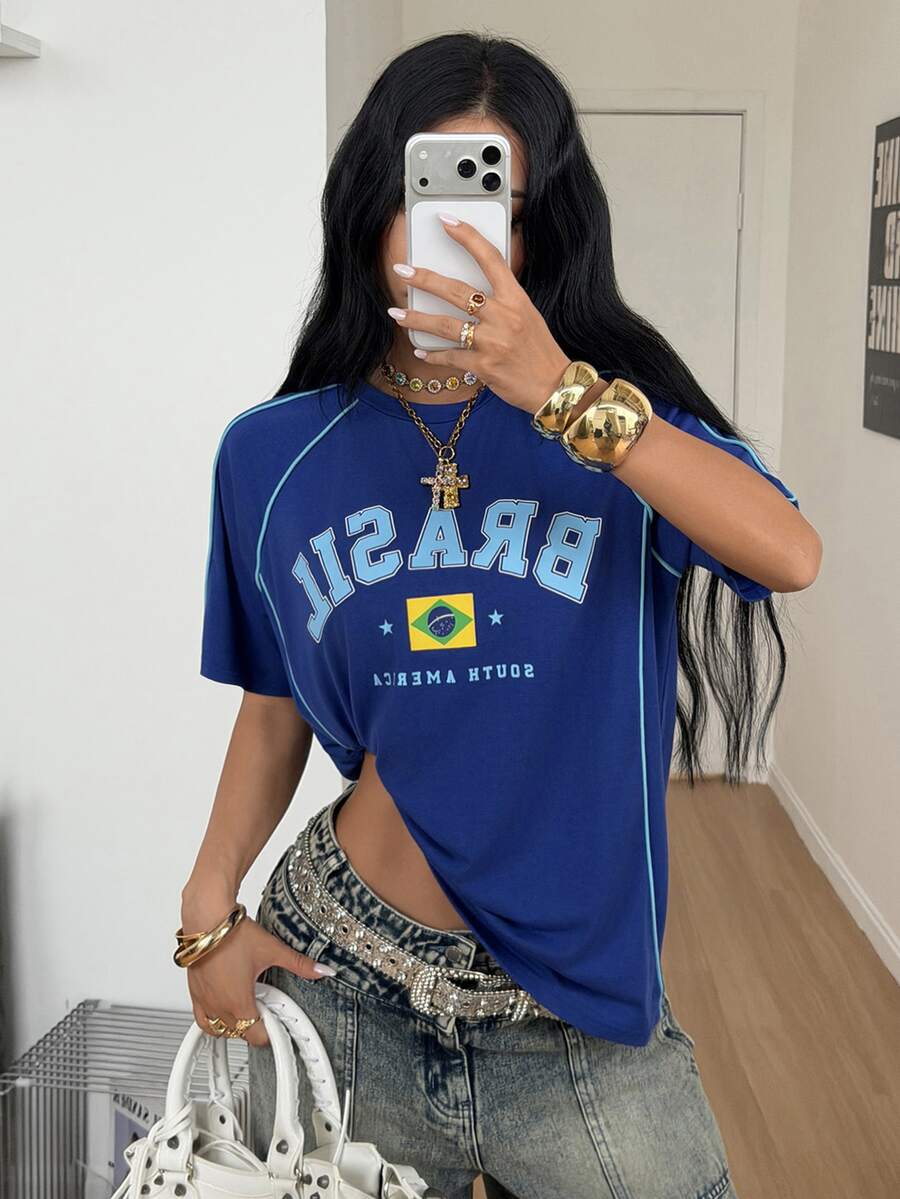 Yellow oversized graphic t-shirt featuring Brazil letter print on the front with contrast raglan sleeves and side stripe detailing.
