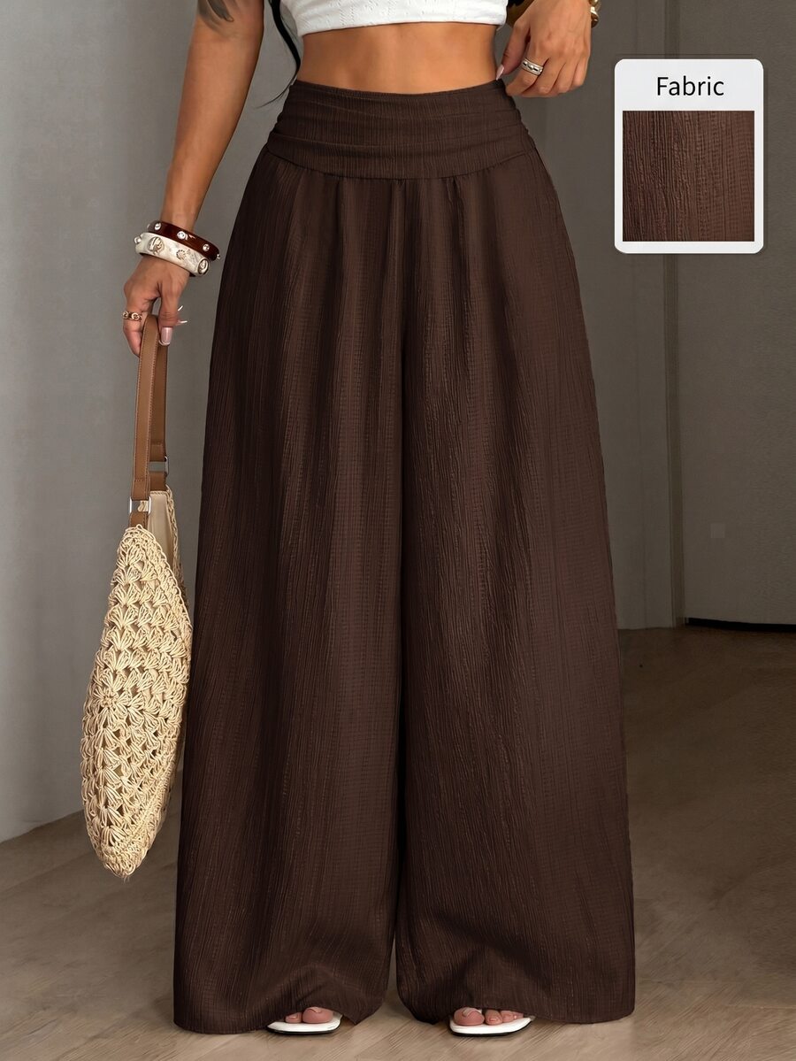 Women's plus size high-waist pleated wide leg pants in textured woven fabric with pockets