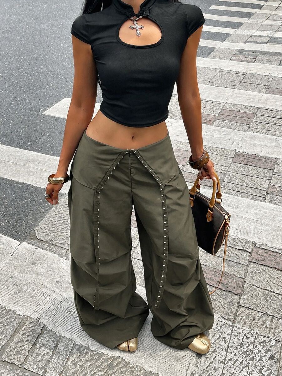 Women's low rise parachute cargo pants featuring a loose straight leg cut, functional pockets, zipper fly, and subtle studded accents.